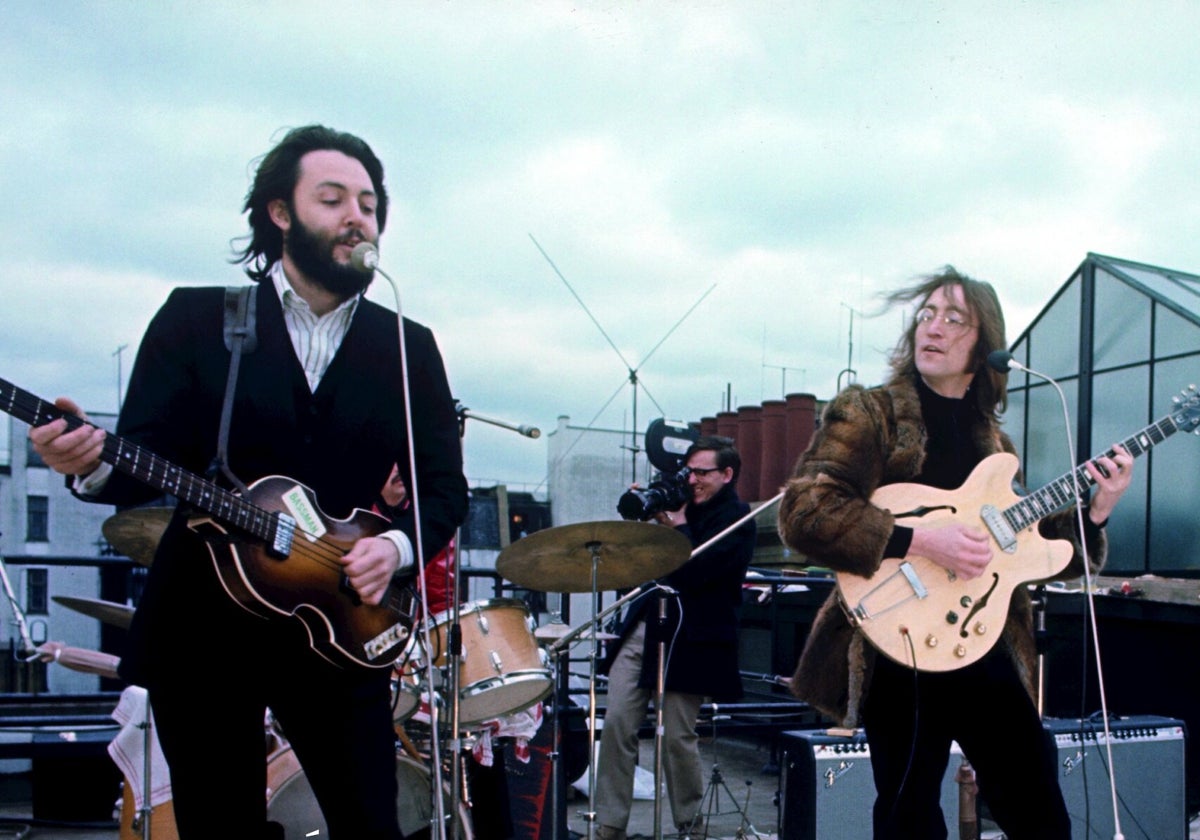 The Beatles perform on the roof of the Apple building.