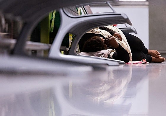 A homeless person sleeps at terminal T3 in Malaga Airport.