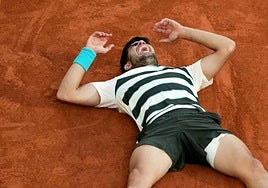 Alcaraz hits the ground to celebrate the trophy-winning point.