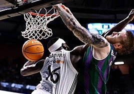 Real Madrid's Garuba fouls Unicaja's Balcerowski.