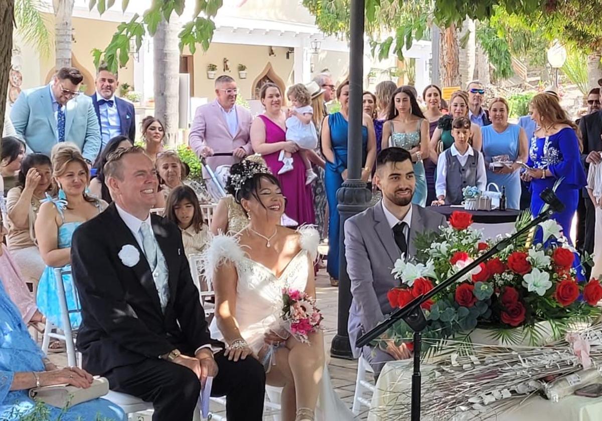 The happy couple with family and friends during the ceremony.
