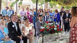 The happy couple with family and friends during the ceremony.
