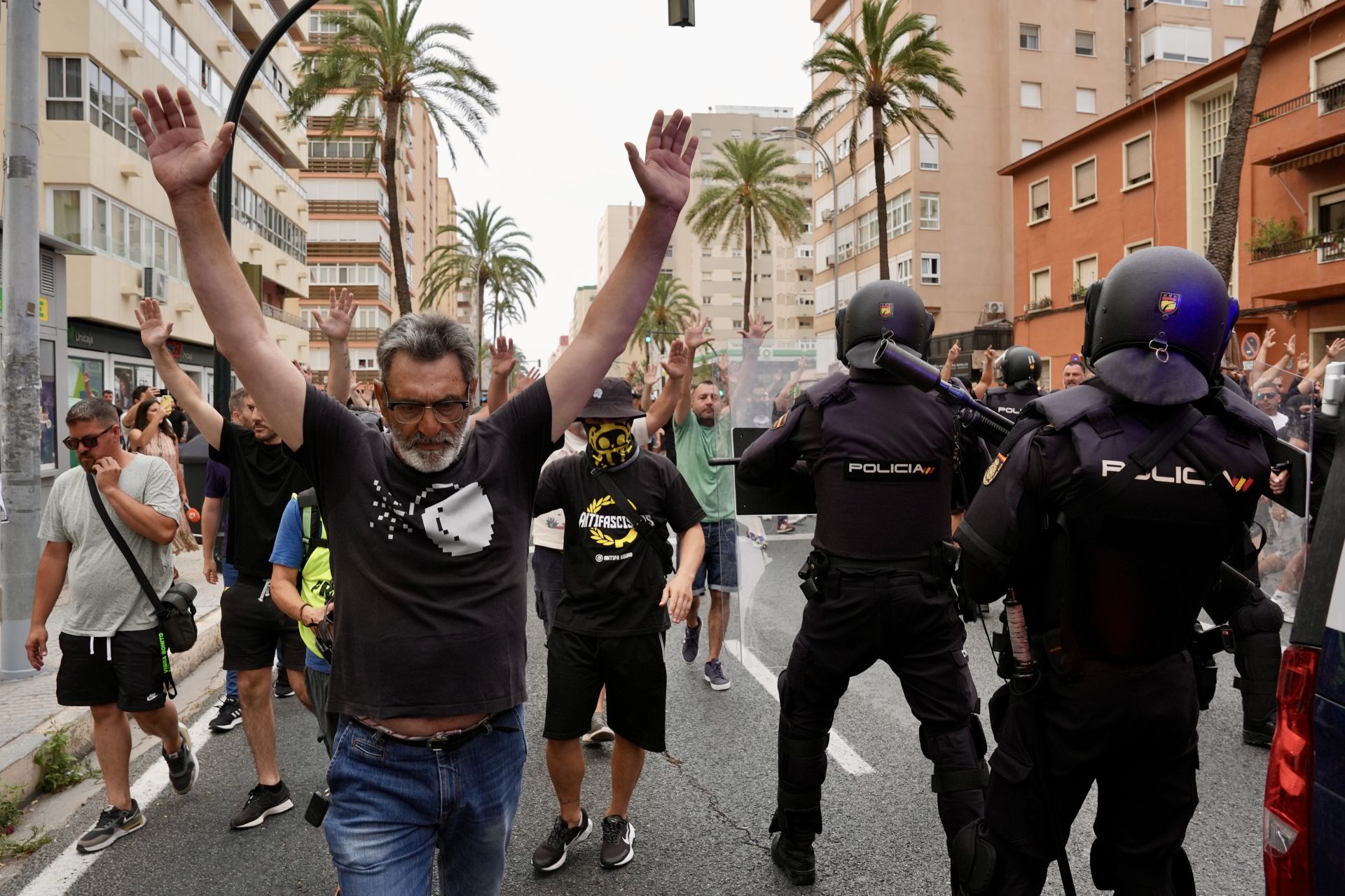 Strikers pass police.