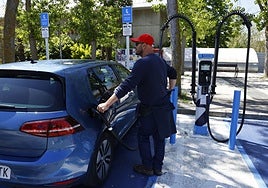 A motorist recharging his electric vehicle.