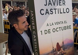 Writer Javier Castillo unveiling the cover to his latest work at the Madrid book fair.