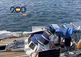 Police board one of the vessels seized.