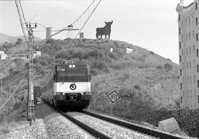 Commuter train passing through a still barely developed Costa del Sol.