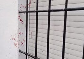 Traces of blood on the wall of a house in the street where the incident happened.