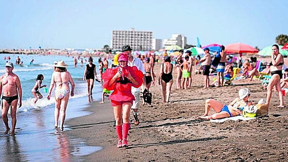 Who is the woman in red walking the length of the Costa del Sol?