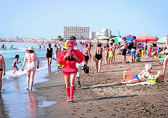 Who is the woman in red walking the length of the Costa del Sol?