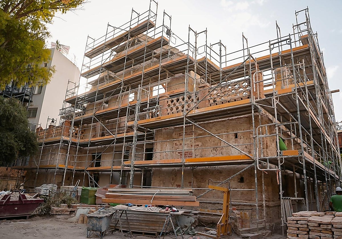 The roof tiling and the building's exterior coatings have been removed.