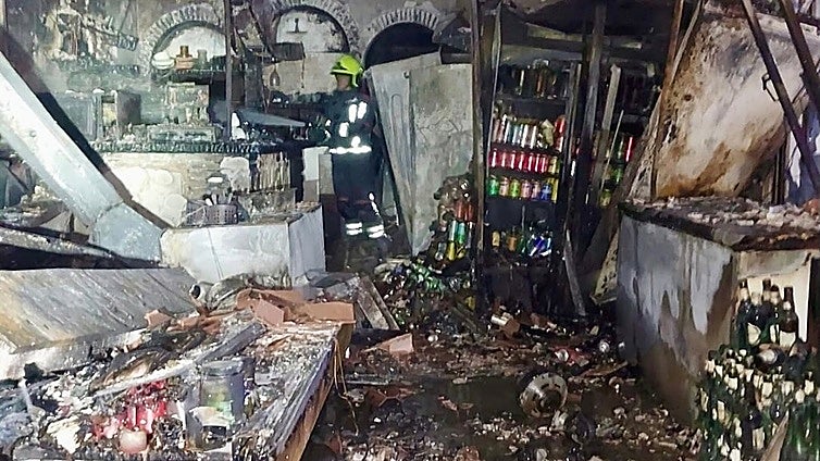 Police forensic experts investigate what sparked fire that severely damaged seven pubs on the Costa del Sol