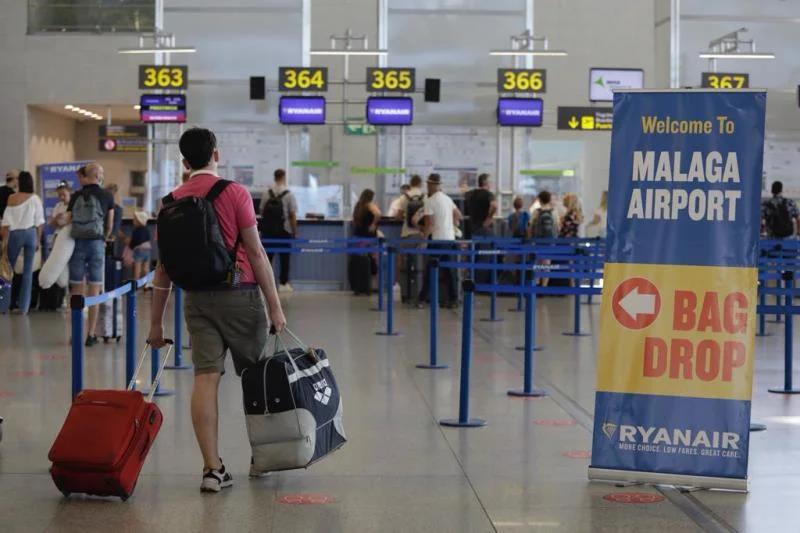 File image of passenger with luggage arriving at Ryanair check-in desks at Malaga Airport.
