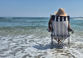A beachgoer enjoys the sun and the sea on the Costa del Sol.