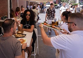 Hospitality workers waiting tables this summer in Malaga.