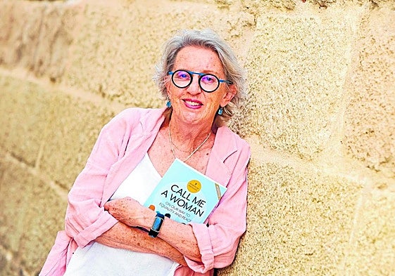 Laurie Levin posing with her book Call Me a Woman about the benefits of gender equality for world peace.