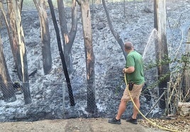 Damping down one of the affected areas after this morning's fire.