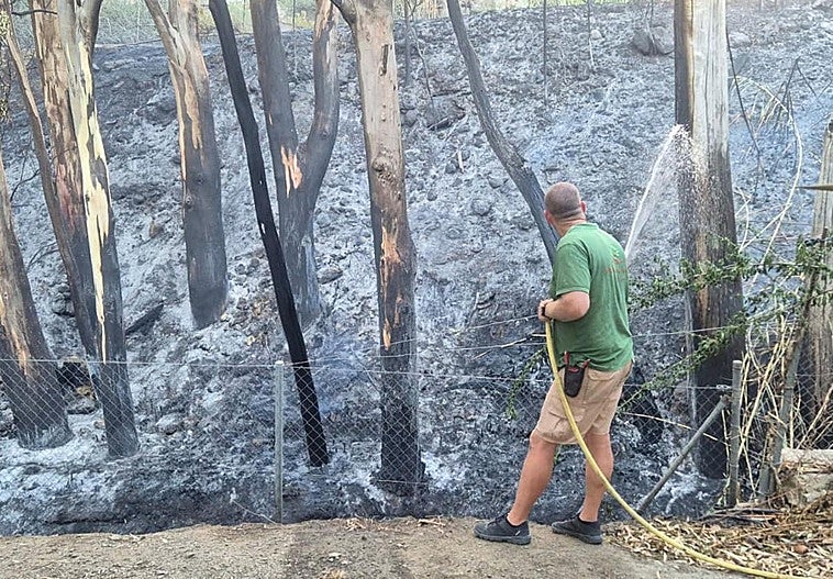 Damping down one of the affected areas after this morning's fire.