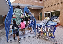 Children head to their new classroom at a school in Malaga.