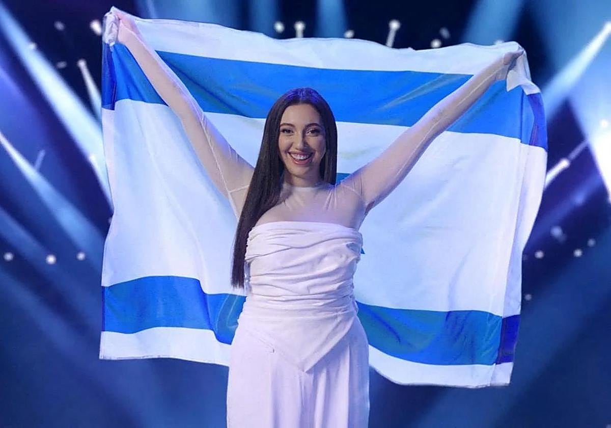Eurovision representative Yuval Raphael poses with her country's flag.