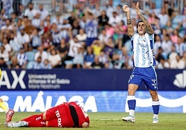 Malaga striker Eneko Jauregi appeals for a late handball.