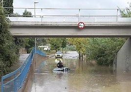 A person trapped on the roof of a vehicle after the heavy rains in the north of Spain.