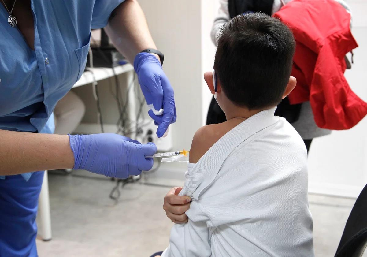 A child receives a coronavirus vaccine.