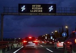 Cars driving along the V30 in Valencia where gantry signs warn of the risk of rain.