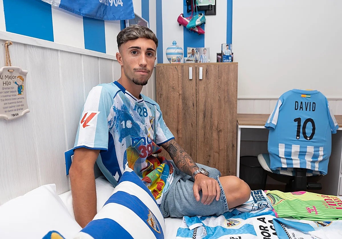 Larrubia poses with images and shirts from his childhood.