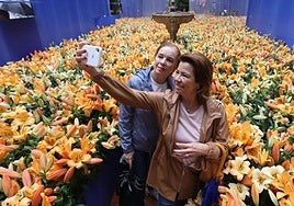 Two of the Flora festival's many helpers snap a quick selfie amid the flowers being installed.