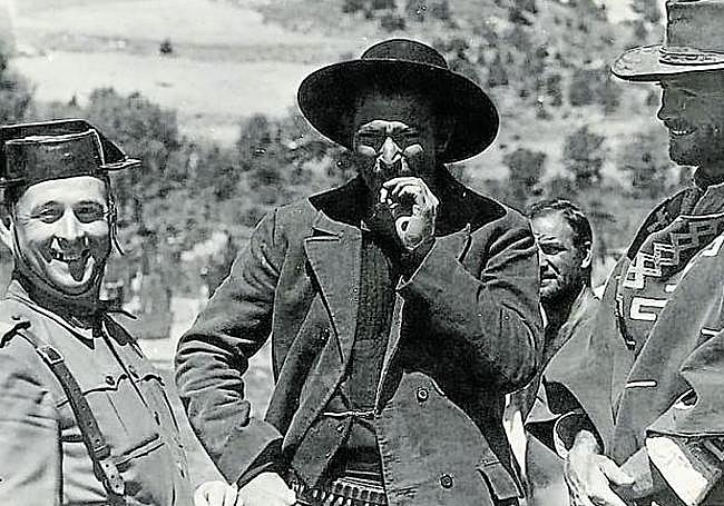 The good, the bad and the policeman. Clint Eastwood and Lee Van Cleef pose alongside a smiling civil guard during a break from filming the 1966 movie.
