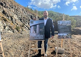 Javier Lazpita poses next to one of the posters, marking the moment the first stone was laid.