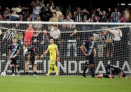 The devastated Malaga players after conceding the late goal.