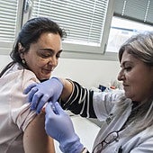 A woman receives a vaccine at a health centre.