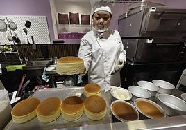 Yeouxiang Wang takes out one of the first batches of cakes before preparing them to take away.