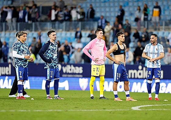 Malaga players at full time react to a chorus of boos.