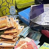 Archive image of cash and condoms seized in a police operation against sexual exploitation.