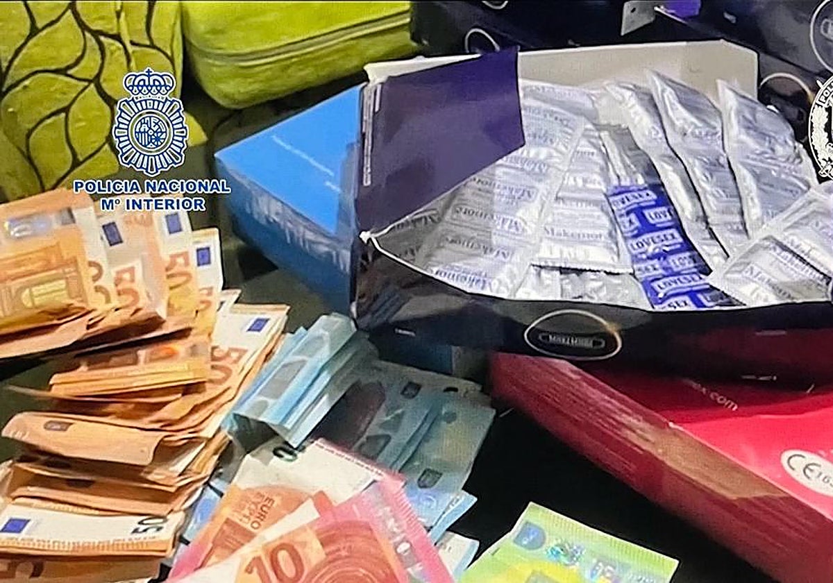 Archive image of cash and condoms seized in a police operation against sexual exploitation.