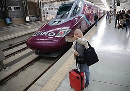 File image of a passenger taking a selfie in front of an Avlo train at Malaga station.