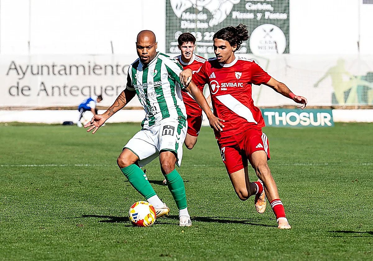 Antequera's veteran winger Biabiany shields the ball against Sevilla B.