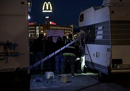 Police inspecting the motorhome wheel arch where the gun was found.