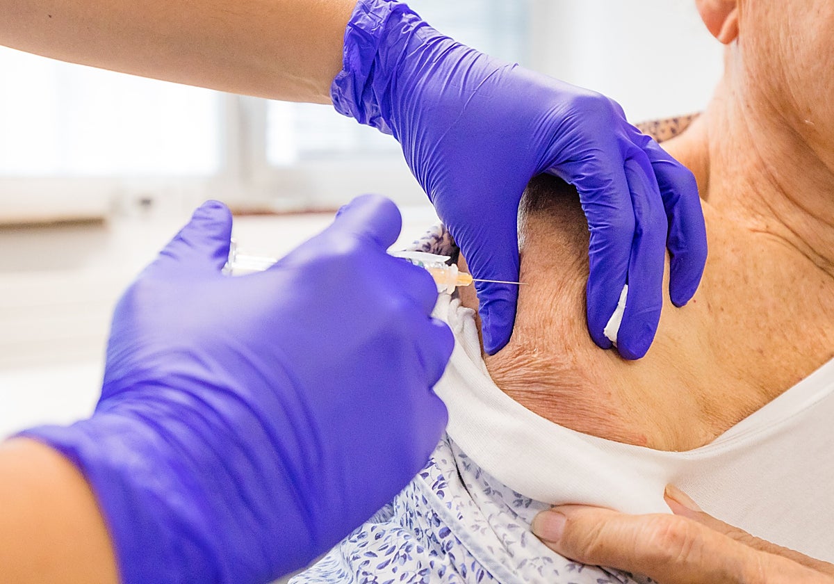 A woman gets a flu vaccine.