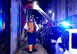 A fireman leaves the doorway in A Coruña on Thursday where a man died in a fire.