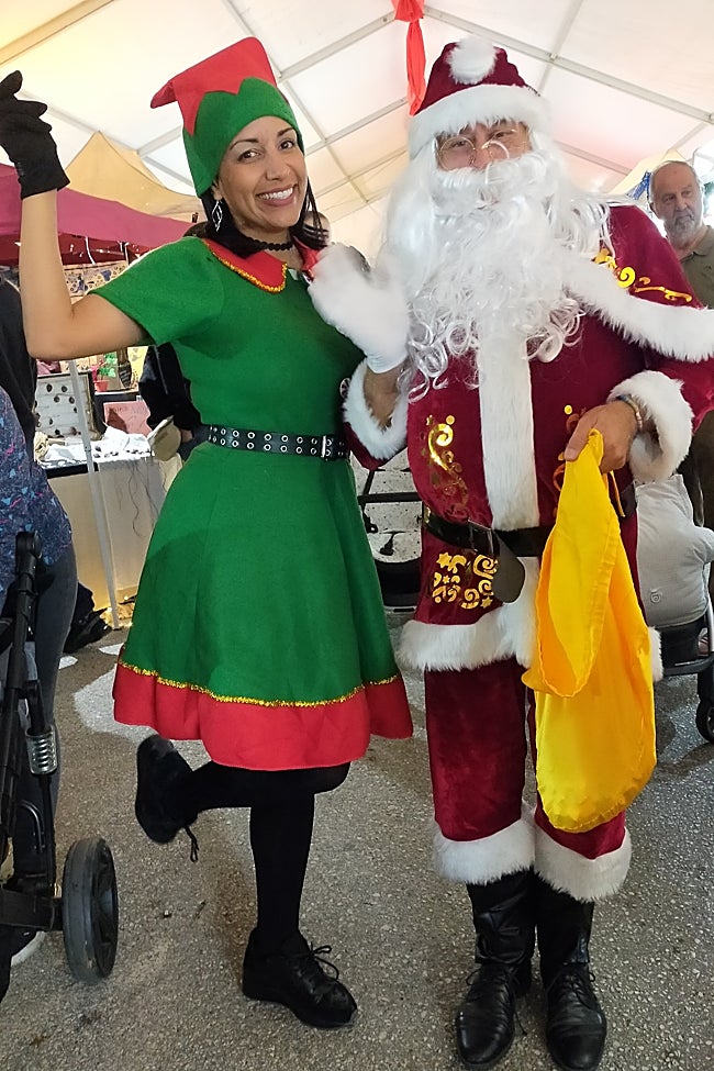 Father Christmas and his elf in 2024