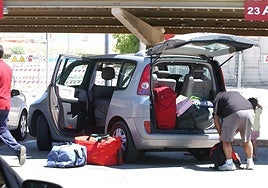 Tourists load rented car at Malaga Airport.