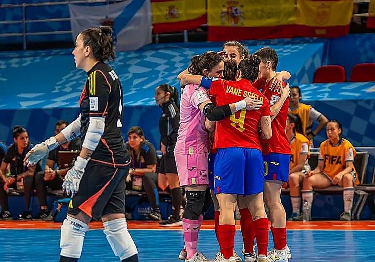 The Spain players celebrate one of their five goals.
