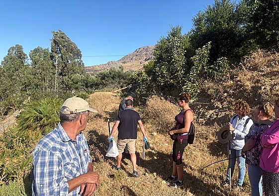 Local residents and Guardia Civil officers during a search which led to the discovery of the weapon in July.