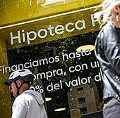A high street shop window promoting mortgage products in Madrid.