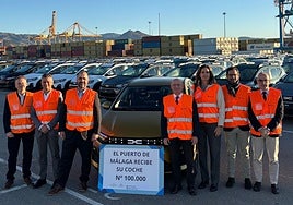 Port officials and company representatives, with the 100,000th car for this year.