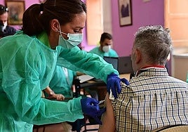 A user is vaccinated at a health centre.